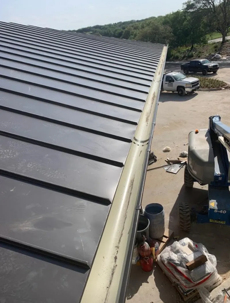 Standing seam panel and gutter detail on a metal roofing jobsite in Piedmont